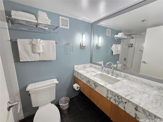 full bathroom featuring sink, tiled shower / bath, tile patterned floors, and toilet