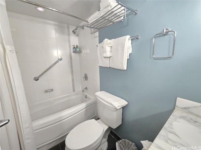 bathroom featuring shower / bathtub combination with curtain and toilet