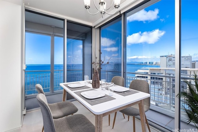 interior space with a water view, floor to ceiling windows, an inviting chandelier, and plenty of natural light