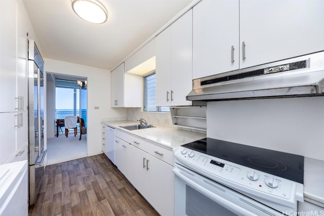 kitchen featuring white cabinetry, dark hardwood / wood-style floors, sink, and white range with electric stovetop