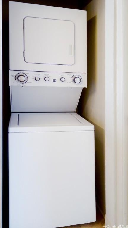 clothes washing area with stacked washer / drying machine