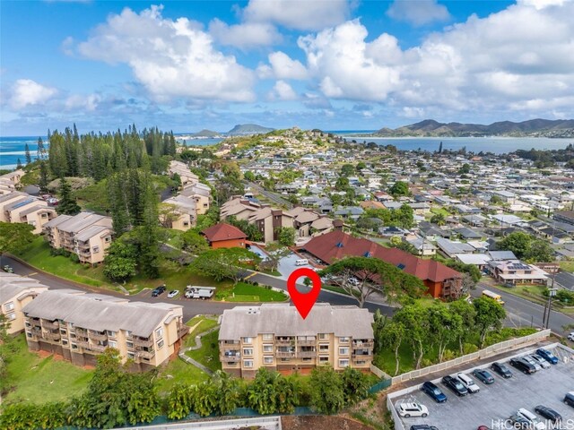 birds eye view of property with a water and mountain view