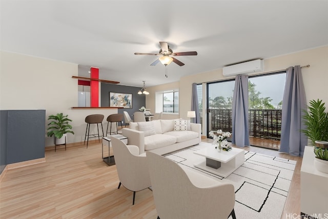 living room featuring ceiling fan, a wall mounted AC, and light wood-type flooring