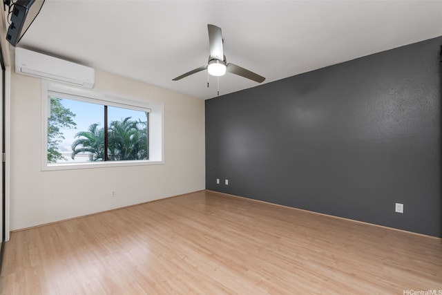 46-010 Aliikane Pl Unit 212, Kaneohe, HI 96744 - unfurnished room with a wall unit AC, a ceiling fan, and wood finished floors