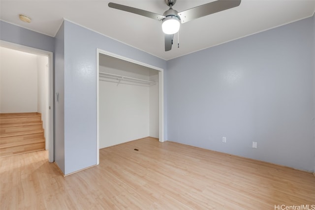 unfurnished bedroom featuring ceiling fan, light hardwood / wood-style floors, and a closet