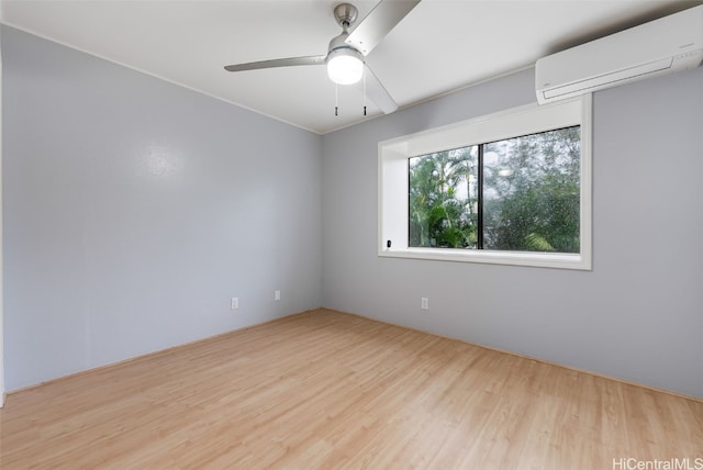 unfurnished room featuring light hardwood / wood-style flooring, a wall unit AC, and ceiling fan