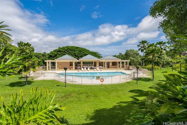 view of swimming pool featuring a lawn and a patio