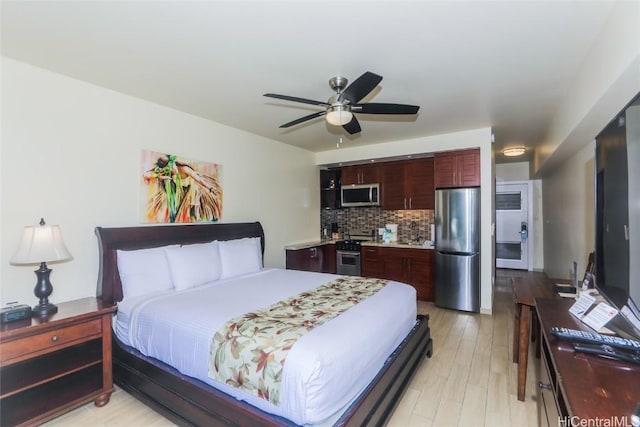 bedroom featuring stainless steel refrigerator, ceiling fan, and light wood-type flooring