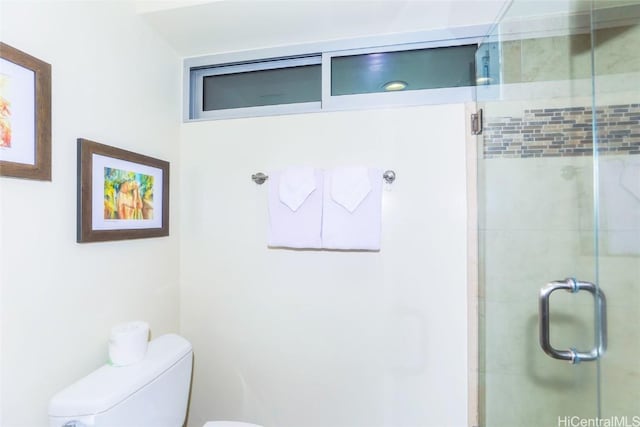 bathroom featuring an enclosed shower and toilet