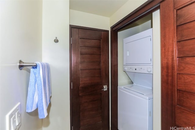 laundry room featuring stacked washer and clothes dryer