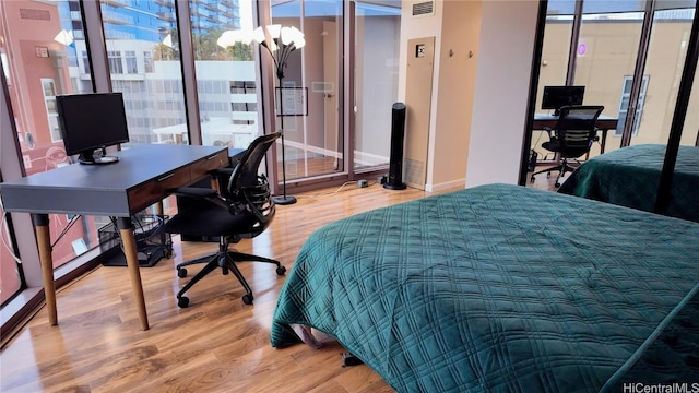 bedroom featuring hardwood / wood-style floors and a chandelier