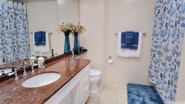 bathroom featuring tile patterned flooring, vanity, and toilet