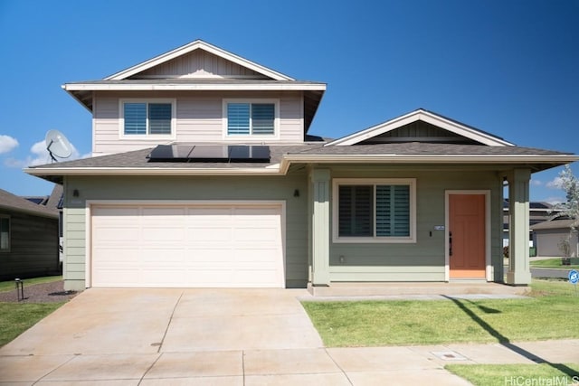 view of front of house featuring solar panels, an attached garage, and concrete driveway