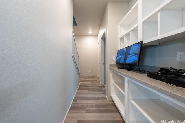 hallway with hardwood / wood-style flooring