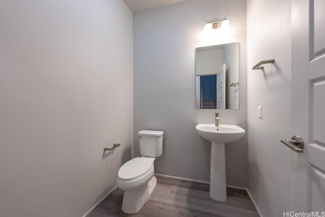 bathroom with wood-type flooring and toilet