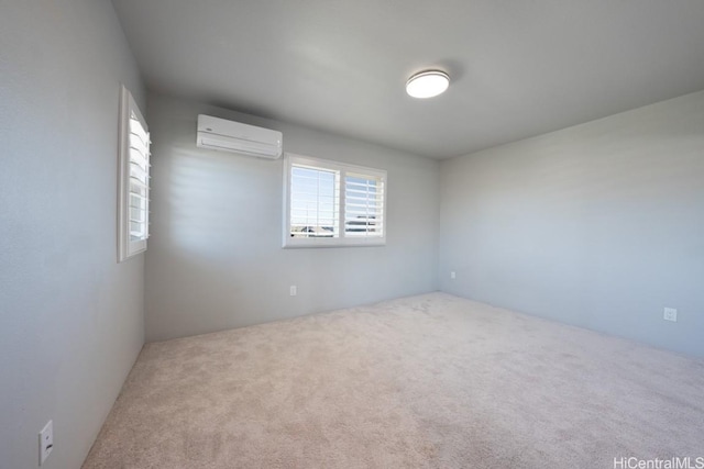 spare room with an AC wall unit and carpet flooring