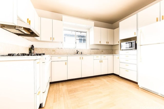 kitchen with white cabinetry, sink, white appliances, and light hardwood / wood-style floors