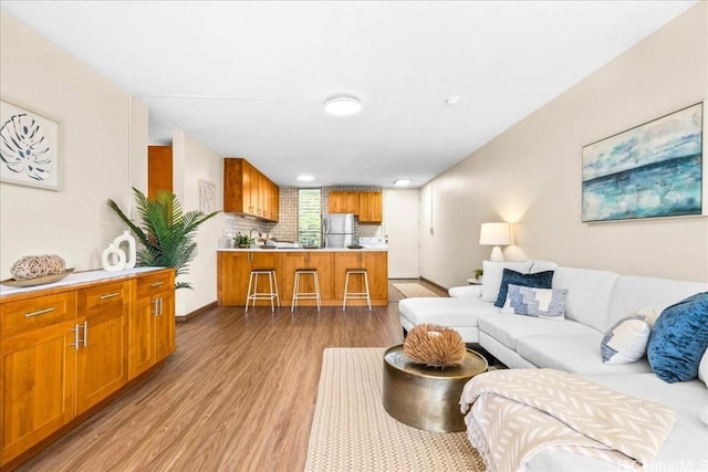 living room with light wood finished floors and baseboards