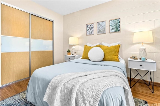 bedroom featuring a closet and wood finished floors