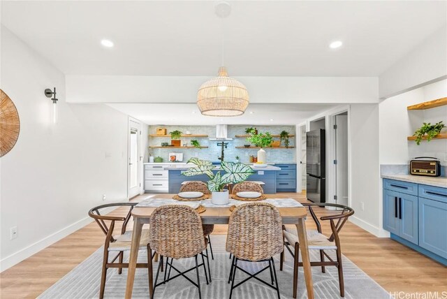 dining space with light wood-type flooring, baseboards, and recessed lighting