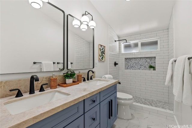 bathroom with marble finish floor, walk in shower, and a sink