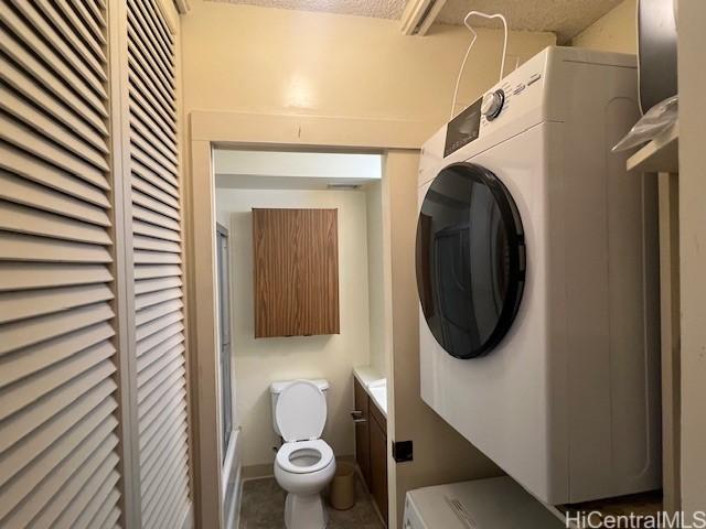 laundry area with stacked washer and dryer