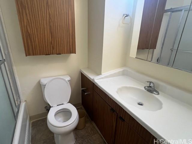 full bathroom with vanity, tile patterned floors, shower / bath combination with glass door, and toilet