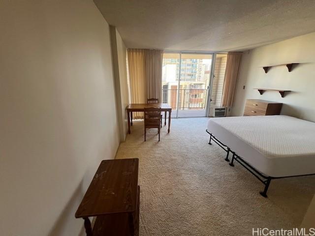 carpeted bedroom featuring a wall of windows and access to outside