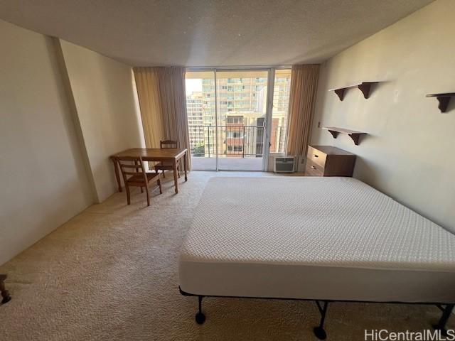 carpeted bedroom featuring expansive windows and access to outside