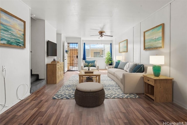 living room with ceiling fan and dark hardwood / wood-style floors