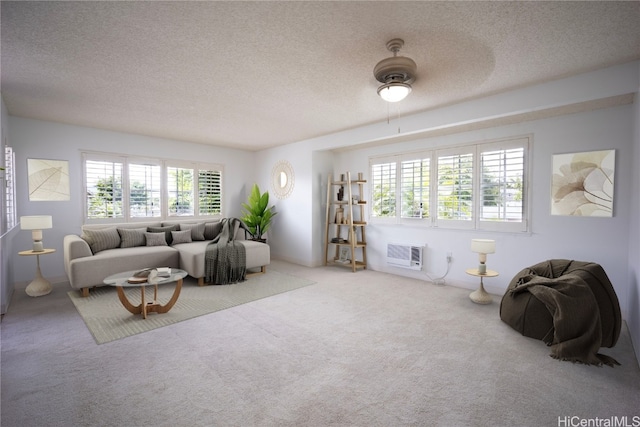 living room featuring carpet flooring, a wall mounted AC, and a textured ceiling