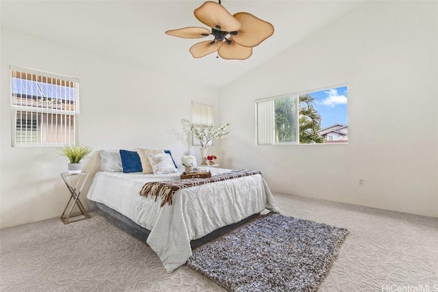 bedroom with lofted ceiling, multiple windows, ceiling fan, and light carpet