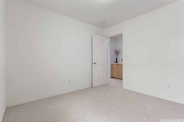 unfurnished room featuring light colored carpet