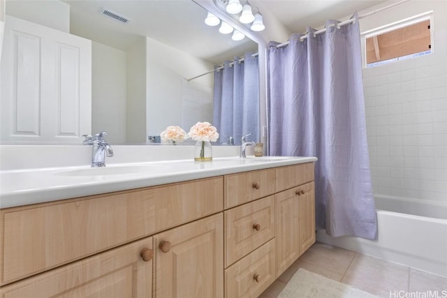 bathroom with shower / bath combination with curtain, visible vents, a sink, and tile patterned floors