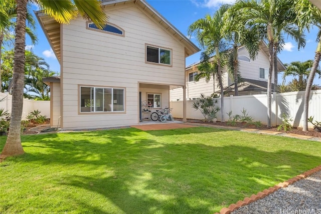 back of house with a lawn, a patio area, and a fenced backyard