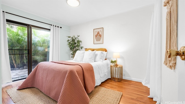 bedroom with access to outside and light hardwood / wood-style floors