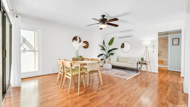 dining area featuring ceiling fan, light hardwood / wood-style floors, and a wall mounted AC