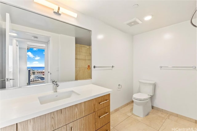 full bathroom with toilet, vanity, baseboards, tile patterned floors, and walk in shower