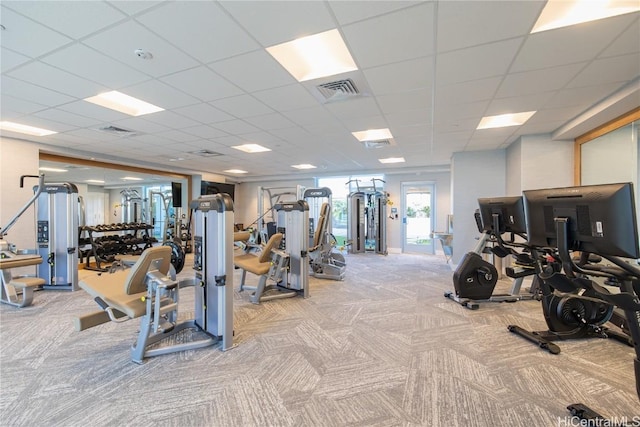 exercise room featuring light carpet and visible vents