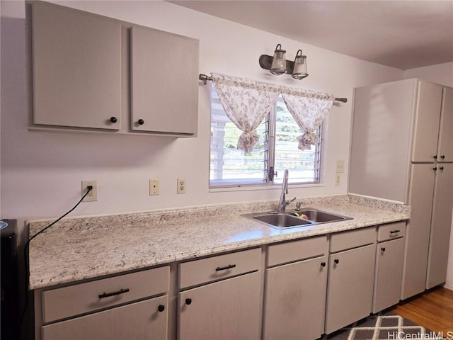 kitchen with sink and light hardwood / wood-style flooring