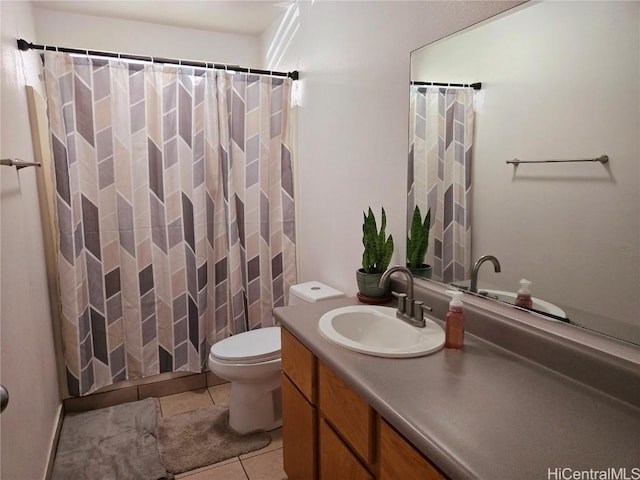 bathroom featuring vanity, tile patterned floors, and toilet