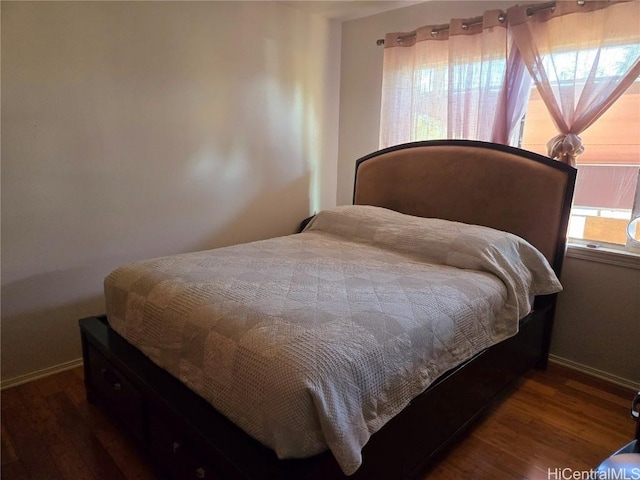 bedroom with dark hardwood / wood-style floors