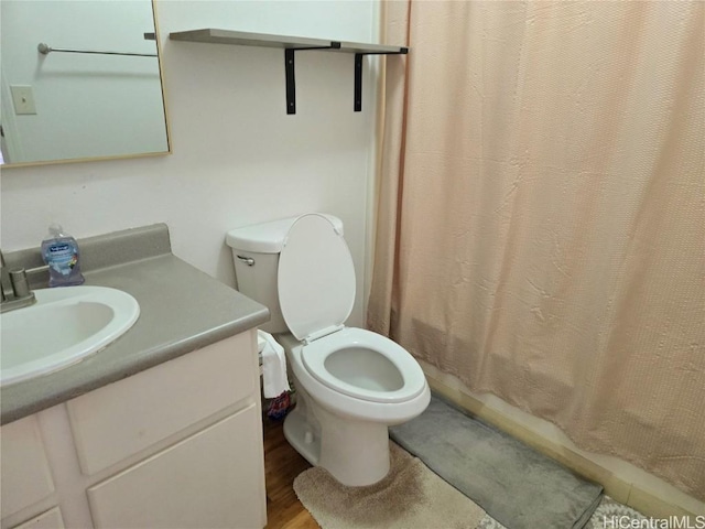 full bathroom with hardwood / wood-style flooring, vanity, toilet, and shower / tub combo