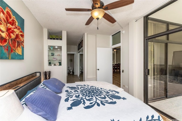 1020 Aoloa Pl Unit 109B, Kailua, HI 96734 - bedroom featuring a textured ceiling, access to exterior, and a ceiling fan