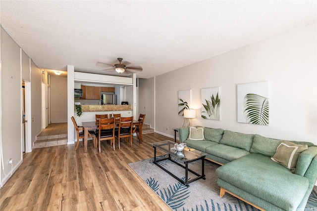 1020 Aoloa Pl Unit 109B, Kailua, HI 96734 - living area featuring wood finished floors, a textured ceiling, baseboards, and ceiling fan