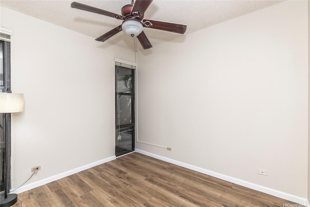1020 Aoloa Pl Unit 109B, Kailua, HI 96734 - unfurnished bedroom with baseboards, wood finished floors, and a textured ceiling
