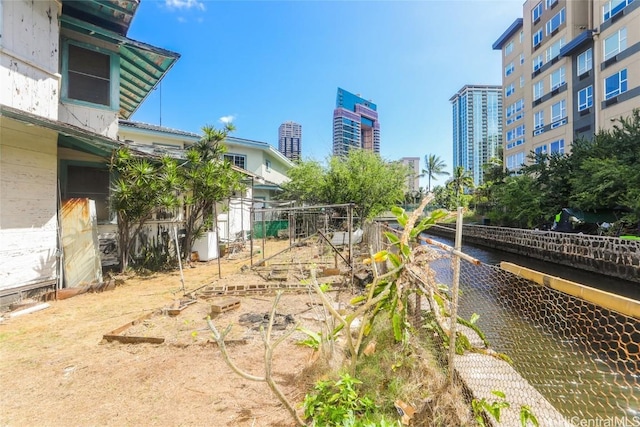 view of yard with a view of city and fence