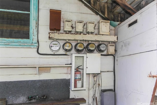 interior details featuring electric meter and a fire extinguisher