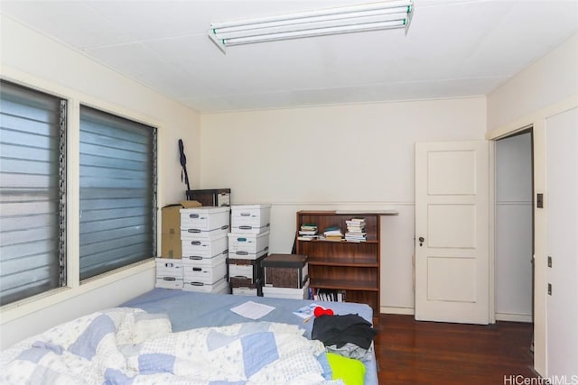 bedroom with dark wood-style floors