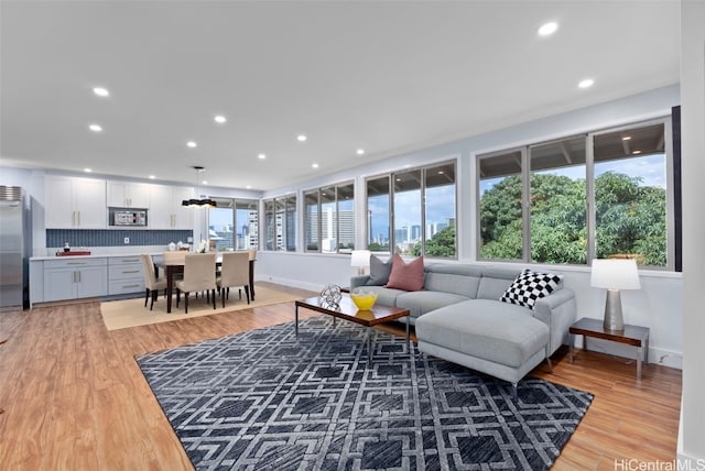 living room with light hardwood / wood-style flooring and a wealth of natural light